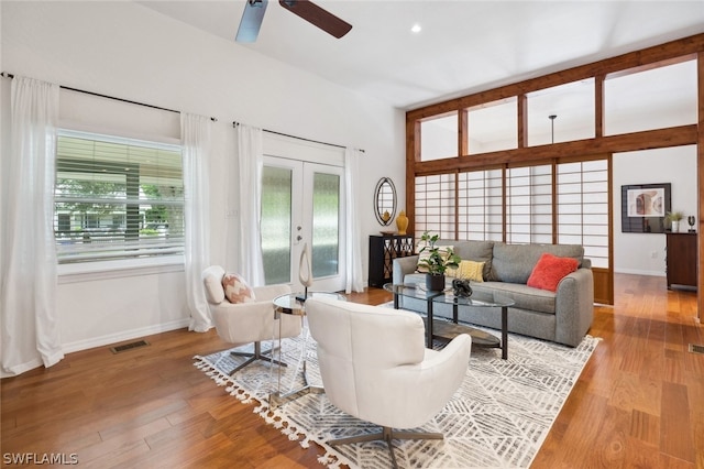 living room featuring french doors, light hardwood / wood-style flooring, and ceiling fan