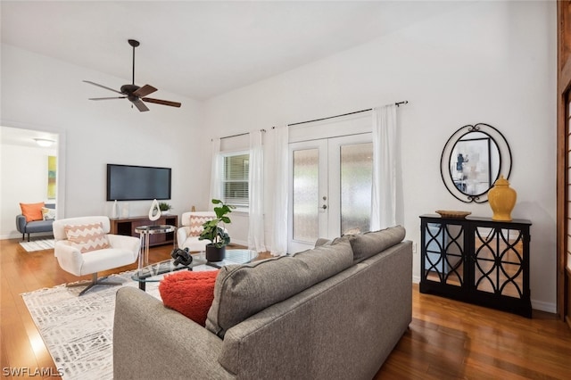 living room featuring dark wood-type flooring, french doors, ceiling fan, and lofted ceiling