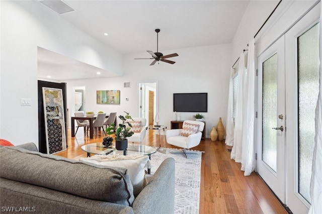 living room featuring light hardwood / wood-style floors and ceiling fan