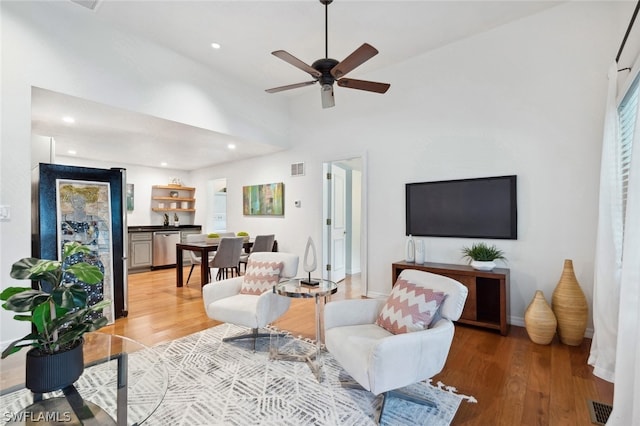 living room featuring hardwood / wood-style flooring and ceiling fan