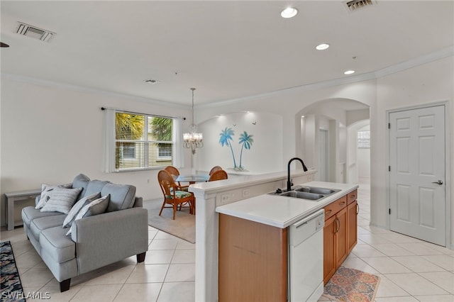 kitchen featuring dishwasher, a kitchen island with sink, hanging light fixtures, sink, and a chandelier