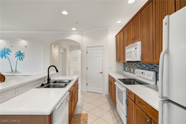 kitchen featuring white appliances, crown molding, sink, an island with sink, and light tile patterned flooring