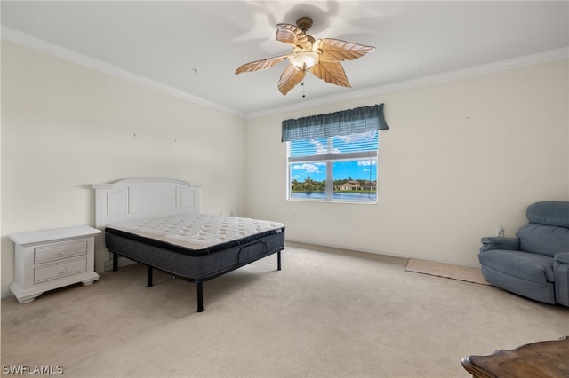 bedroom with ceiling fan, light carpet, and ornamental molding