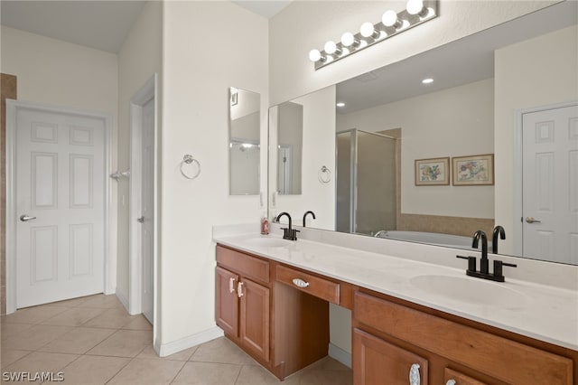 bathroom with tile patterned flooring, vanity, and separate shower and tub