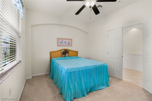 bedroom featuring ceiling fan and light carpet