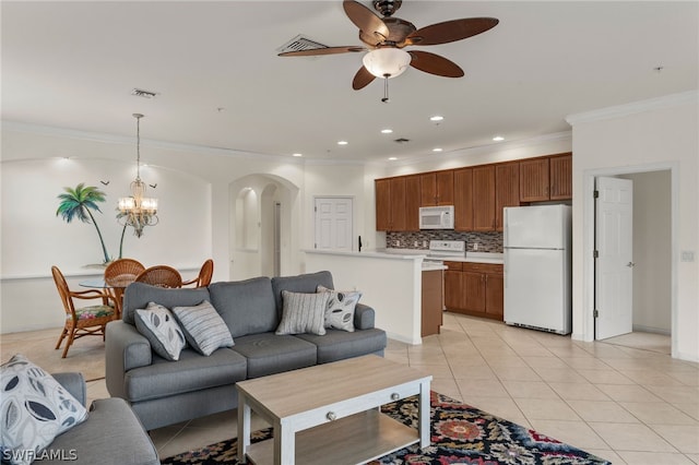 tiled living room featuring ceiling fan with notable chandelier and ornamental molding