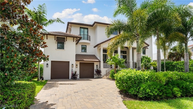 view of front of property with a balcony and a garage