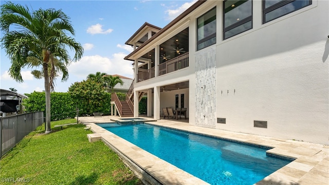 view of swimming pool with an in ground hot tub, a patio, ceiling fan, and a lawn