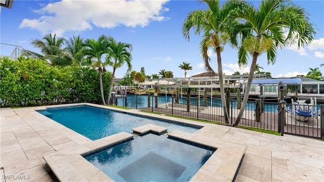 view of pool with an in ground hot tub and a water view