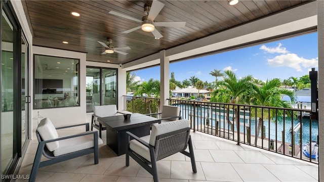 exterior space with ceiling fan and a water view