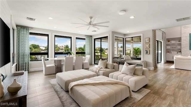 bedroom featuring access to outside, light hardwood / wood-style flooring, and ceiling fan