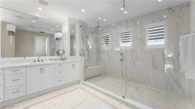 bathroom with vanity and a shower with shower door