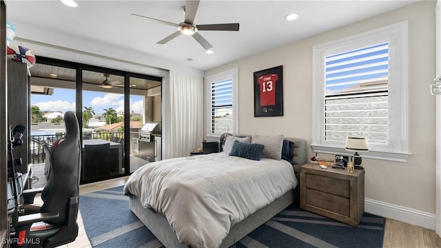 bedroom with access to exterior, baseboards, wood finished floors, and recessed lighting