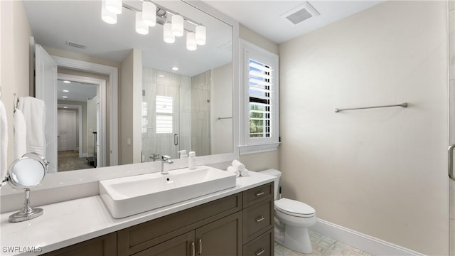 full bath featuring toilet, a stall shower, visible vents, and baseboards