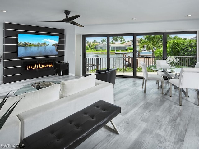 living room featuring a fireplace, ceiling fan, and hardwood / wood-style floors