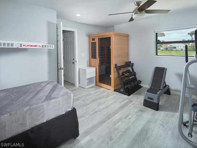 bedroom with ceiling fan and light hardwood / wood-style flooring