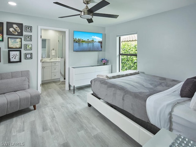 bedroom featuring ceiling fan, light wood-type flooring, and connected bathroom