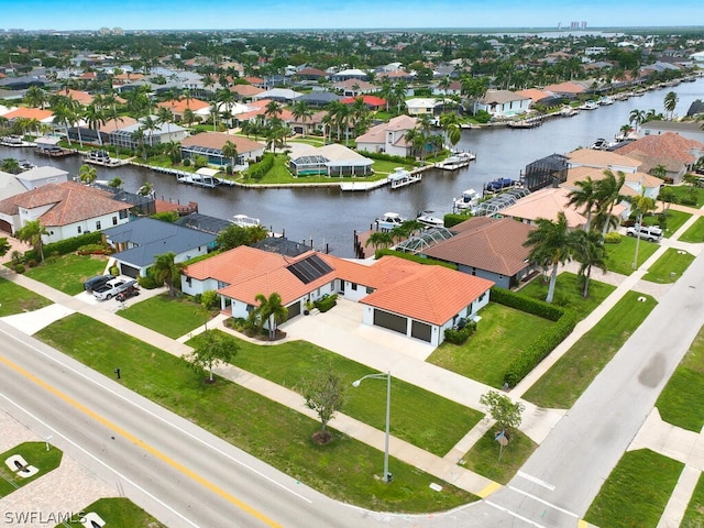 birds eye view of property with a residential view and a water view