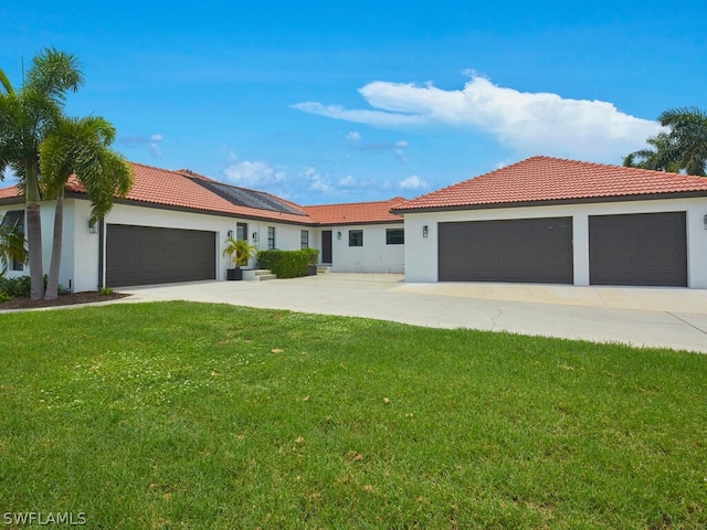 view of front of home with a front yard and a garage