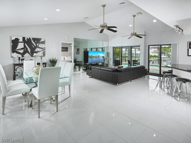 dining room with light tile patterned floors, visible vents, and high vaulted ceiling