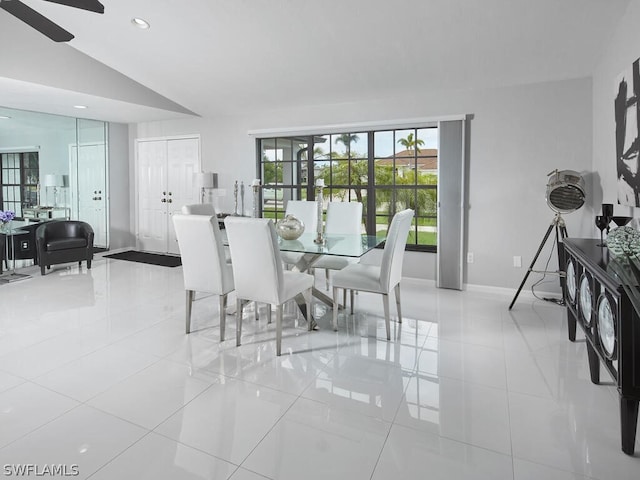 tiled dining area featuring vaulted ceiling