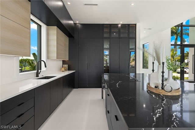 kitchen featuring dark stone countertops and sink