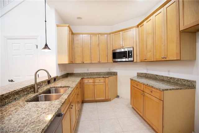 kitchen featuring light stone counters, sink, pendant lighting, light brown cabinets, and light tile patterned flooring