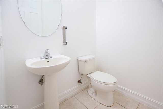 bathroom with tile patterned floors and toilet