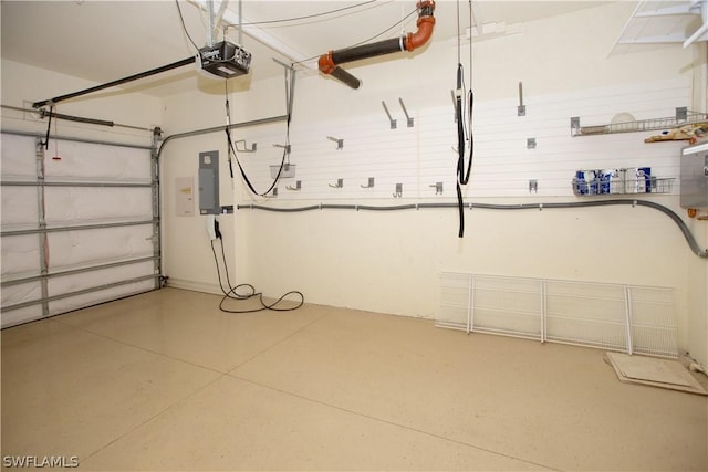 garage with a garage door opener and electric panel