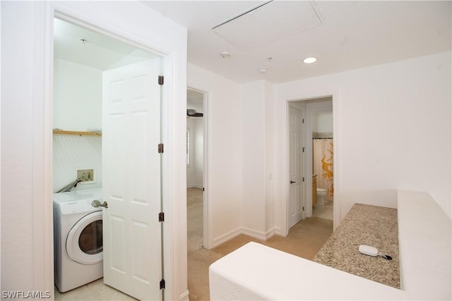 laundry area with light carpet and washer / dryer