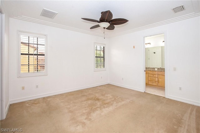 carpeted empty room featuring ceiling fan and crown molding