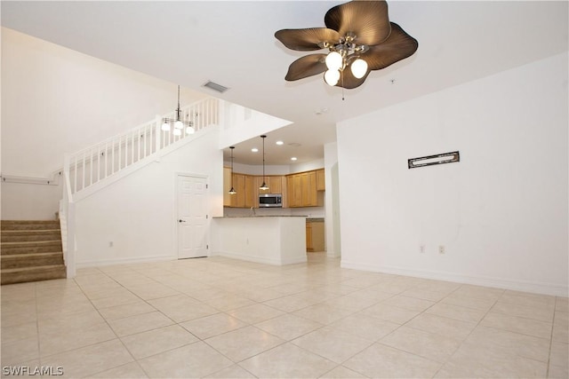 unfurnished living room with ceiling fan and light tile patterned floors