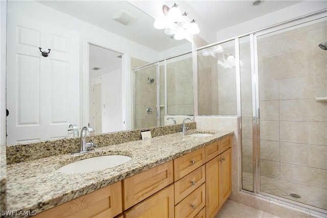 bathroom featuring tile patterned floors, vanity, and walk in shower