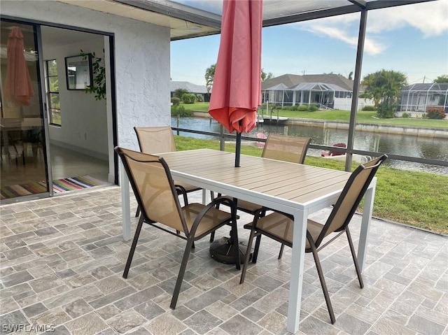 sunroom / solarium with a water view