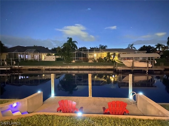 dock area featuring a water view and a patio