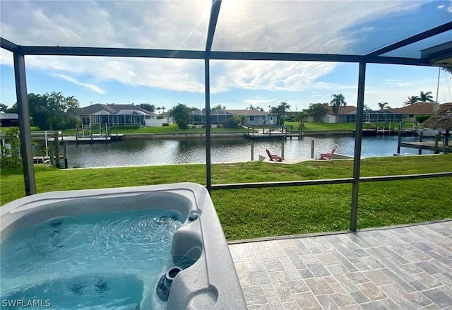 view of swimming pool featuring glass enclosure, a dock, a lawn, and a water view