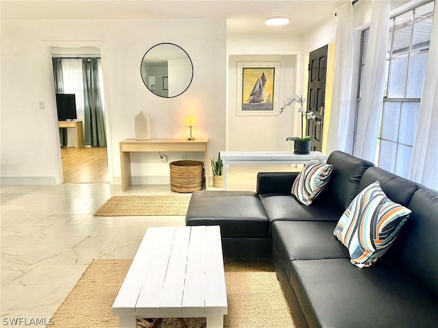 living area with marble finish floor and baseboards