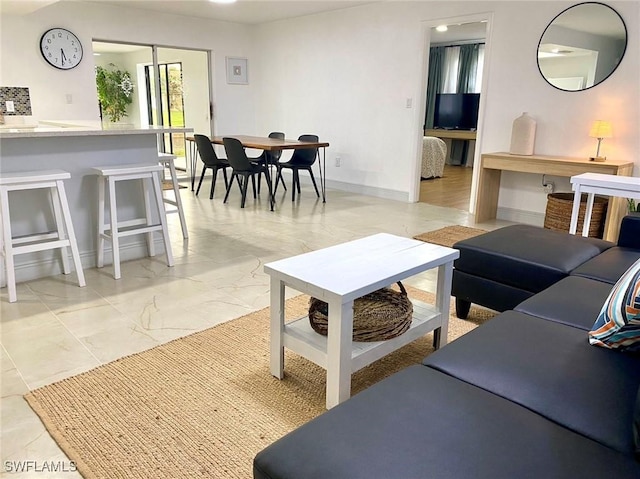 living room with marble finish floor and baseboards