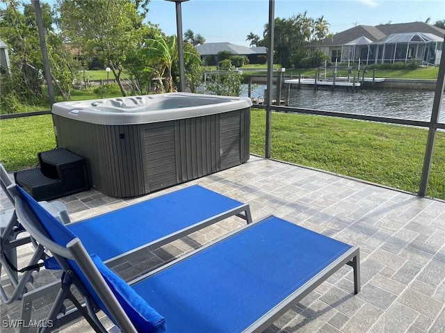 exterior space featuring a residential view, a water view, and an outdoor hot tub