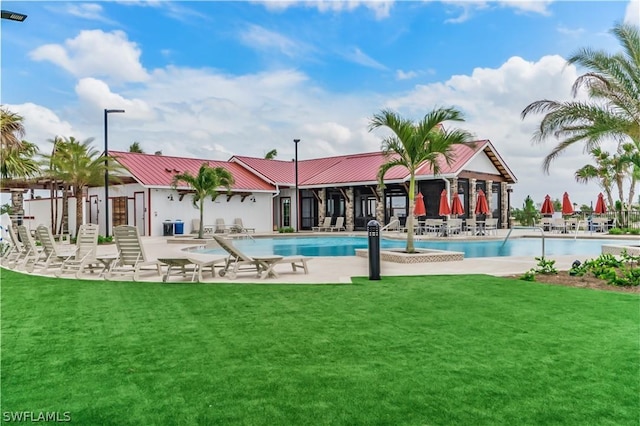 view of swimming pool with a patio area and a yard