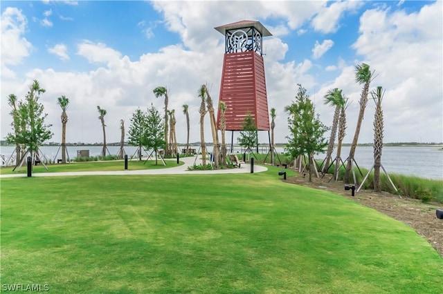 view of home's community with a yard and a water view