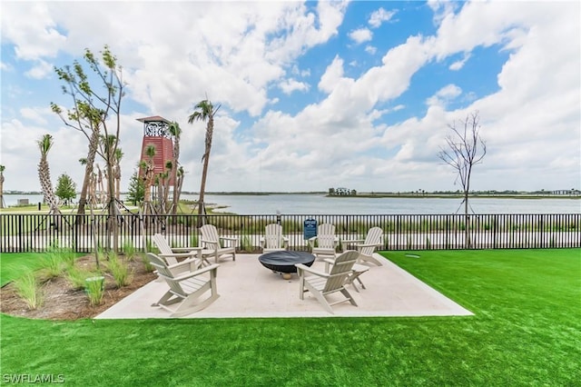 view of patio with a fire pit and a water view