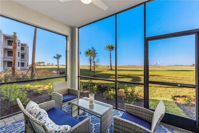 sunroom / solarium featuring ceiling fan