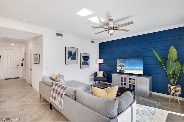 living room with tile patterned flooring, ceiling fan, and crown molding