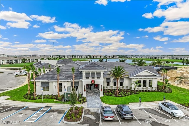 43030 Greenway Blvd Unit 412, Punta Gorda, FL 33982 - view of building exterior featuring uncovered parking and a water view