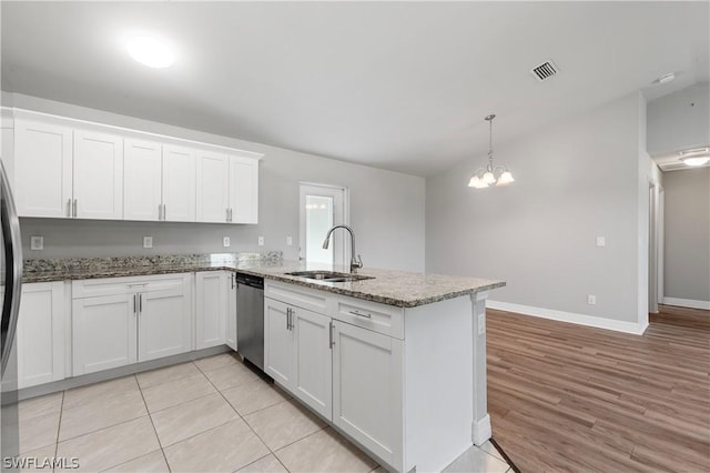 kitchen featuring sink, light hardwood / wood-style flooring, stainless steel dishwasher, decorative light fixtures, and white cabinets