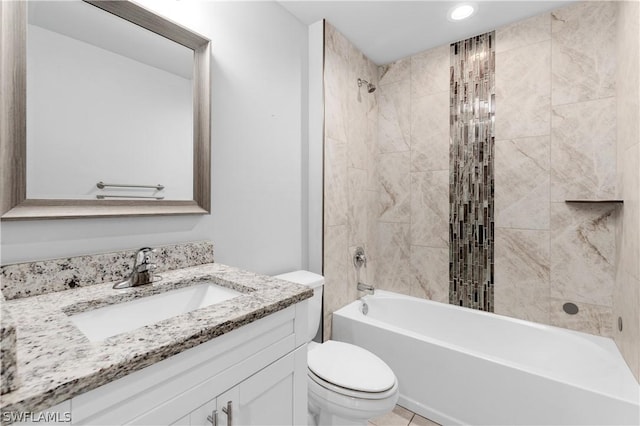 full bathroom featuring tile patterned floors, vanity, tiled shower / bath combo, and toilet