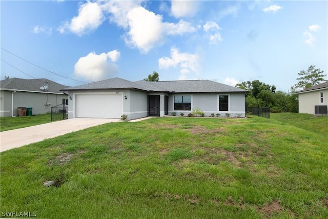 ranch-style house with a garage and a front lawn