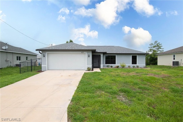 ranch-style home with a front lawn, a garage, and central AC unit