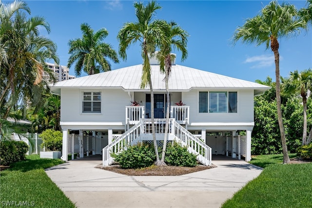 beach home with a porch and a carport